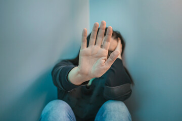 Unrecognizable woman with mental health problems refusing help with hand. Selective focus on hand...