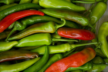 Hot chili pepper background. Red and green peppercorns as a background. Healthy food concept.
