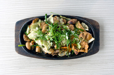 Horumon Sutamina Itame, vegetable stir fry with pork innards served on hot pan. Top View