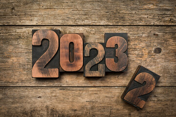 Change from year 2022 to 2023 written with vintage wooden letterpress printing blocks