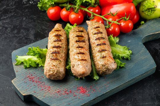 Lyulya vegetarian soy kebab, three sausages on a wooden background.