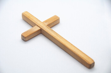 Wooden Cross on white cover background representing Good Friday, Lent Season and Holy Week concept.