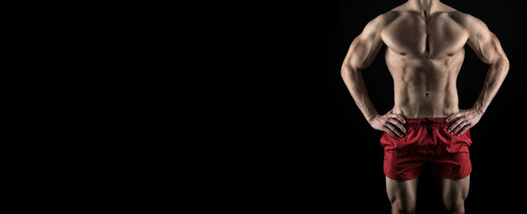 cropped view of fitness man abs. muscular abs of fitness man isolated on black background.