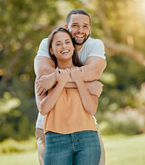 Young couple hugging in park, garden and nature for love, care and romantic date together outdoors...
