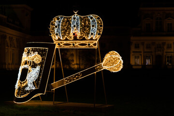 Light decorations in the park. Figures made of Christmas lights that look like gods and planets. An exhibition of decorations from Christmas lights in Poland. - obrazy, fototapety, plakaty