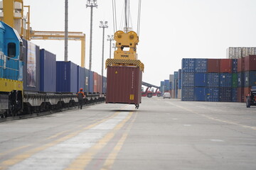 Khorgos, Kazakhstan - 09.22.2022 : Unloading of cargo containers in the dry port of Khorgos.