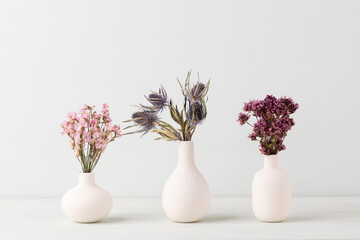 Flower in vase on pastel wall background.
