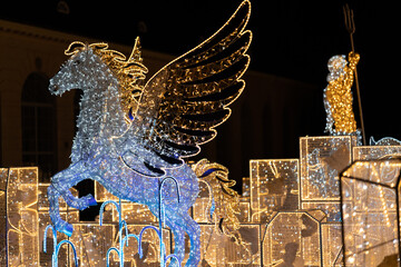 Light decorations in the park. Figures made of Christmas lights that look like gods and planets. An exhibition of decorations from Christmas lights in Poland. © Mateusz Witkowski