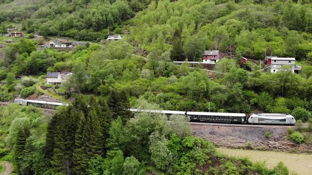 Aerial: Flåm Train Going Uphill Through By A Mountain Side In A Valley