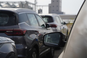 Naklejka premium Khorgos, Kazakhstan - 09.22.2022 : New cars stand in a row in a dry port on the border between Kazakhstan and China.