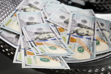 Fototapeta premium Close-up of washing dollars in machine, money laundering, financial fraud concept