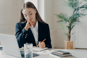 Concentrated business woman thinking about work issues at office
