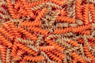 Whole, lentils fusilli pasta background.