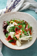 Salad with prosciutto, melon, arugula, mint and fennel. Italian diet salad with dried ham