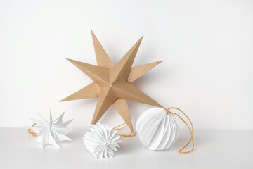 Christmas Paper Star and Ball Decoration. Handmade Christmas Nordic Decor on a Light Background...