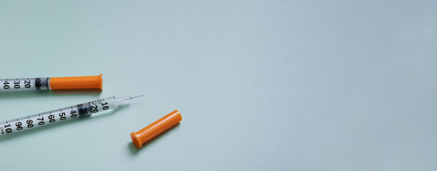 Insulin syringes close-up on a colored background with copy space. Medical banner