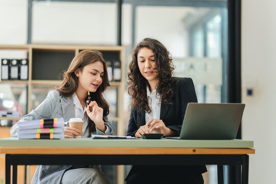 Young colleagues discussing business and price chart analyzes business people on the table great in modern coworking office teamwork concept.