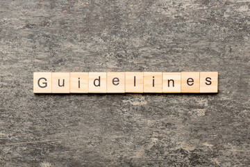 Guidelines word written on wood block. Guidelines text on table, concept - obrazy, fototapety, plakaty