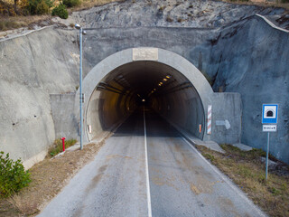 Entrance of road tunnel. Heading through the mountain, on the road.