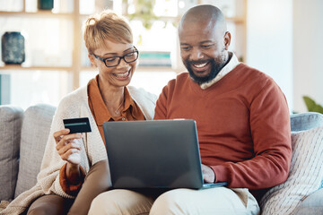 Laptop, credit card and online shopping with a black couple customer spending money or banking at home together. Computer, ecommerce and retail with a mature man and woman shopper in a house