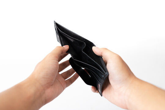 Hands open a black empty wallet with no money inside. Business finance economy resesion crisis concept