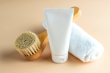 organic cosmetics, body cream, wooden brush, and towel on a beige background. The concept of spa and wellness.