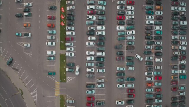 Aerial video footage from a drone of the movement of cars in the parking lot. Parking places. Top view. Timelapse. 
