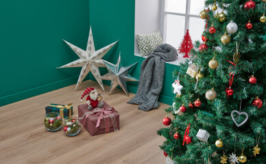 Green corner room style, close up Christmas and new year tree, ornament, accessory, windows, blanket and wooden chair style.