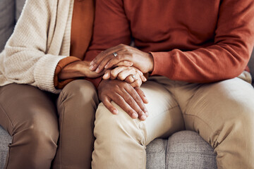 Black couple, holding hands on sofa or comfort support, care and love bonding together in home living room. Black man, black woman sitting couch and embrace with kindness, trust and help with problem