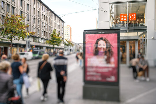 Strasbourg, France - Oct 28, 2022: Street advertising with a young girl wearing a mustache and sexist text wited above by activists