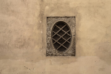 Old window on the dilapidated wall