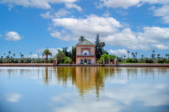 Construction of the Menara Gardens which are the most famous gardens of Marrakech and one of the most visited and touristic places in Morocco with a fortress and a lake that reflects the blue sky.