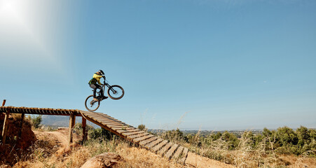 Sports, mountain bike and ramp jump in nature, cycling .and outdoors stunt performance. Fitness,...