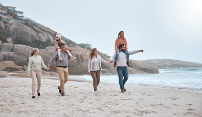 Big family, beach and walking for bonding with generations in winter by the sea water. Mother,...