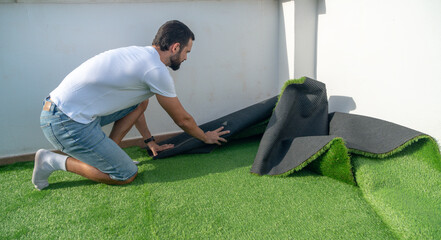 man installing artificial grass