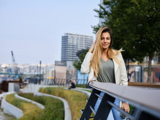 A beautiful trendy woman posing outside in urban exterior.