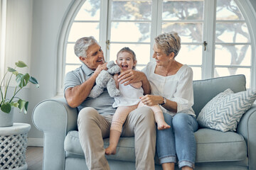 Happy family, grandparents and baby on sofa together talking, bonding and helping with child...