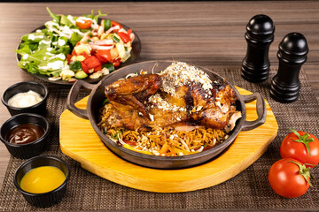 Whole roasted chicken with vegetables, on wooden table,