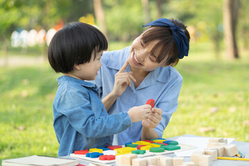 happy holidays, Mum and daughter play together in the park.