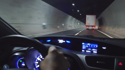 Dash Cam Driving Through Road Tunnel behind Lorry Truck in Alps, Italy Europe - Powered by Adobe