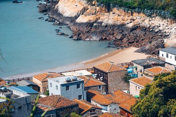 Aerial view of the sea and coastal village on a sunny day