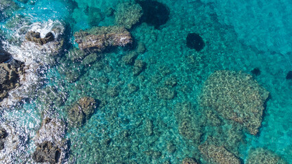 Aerial view of turquoise blue Mediterranean water on the coast of Samos, Greek Aegean Sea