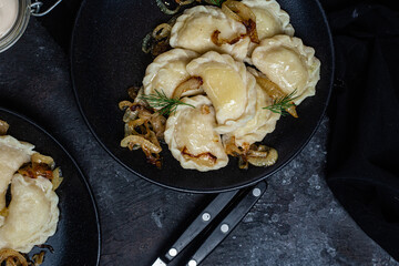 Vareniki with potatoes and onions in a plate. Ukrainian food