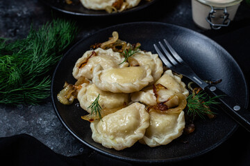 Vareniki with potatoes and onions in a plate. Ukrainian food