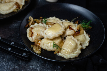 Vareniki with potatoes and onions in a plate. Ukrainian food