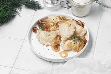 Vareniki with potatoes and onions in a plate. Ukrainian food