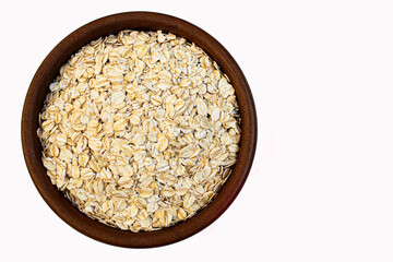 Close-up oats flakes in a wooden bowl