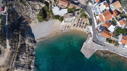 Aerial view of lovely greek fisher town of Armenistis in a quiet summer morning. Port with local beach in transparent clear water at Ikaria, Greece - obrazy, fototapety, plakaty