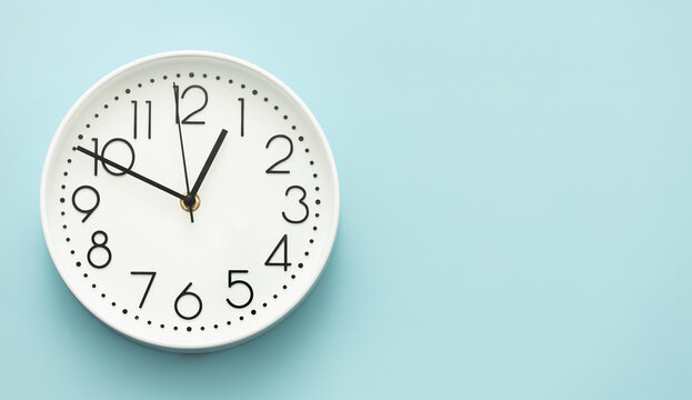 Clock on a blue background, the concept of time management, time planning. Web banner, free space.