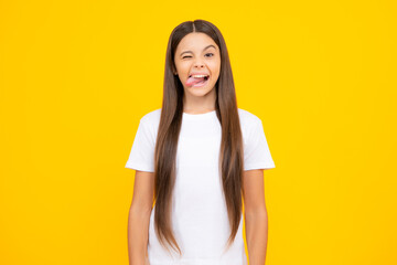 Funny kids face. Portrait of silly teenager child girl smiling and showing tongue in camera making funny faces. © Olena